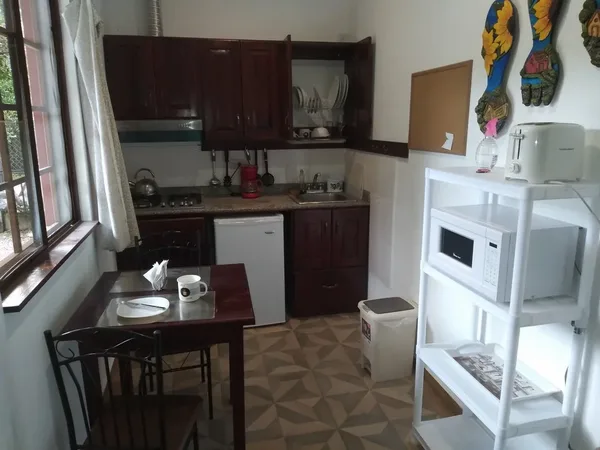 Kitchen with stove, fridge, microwave and dining table